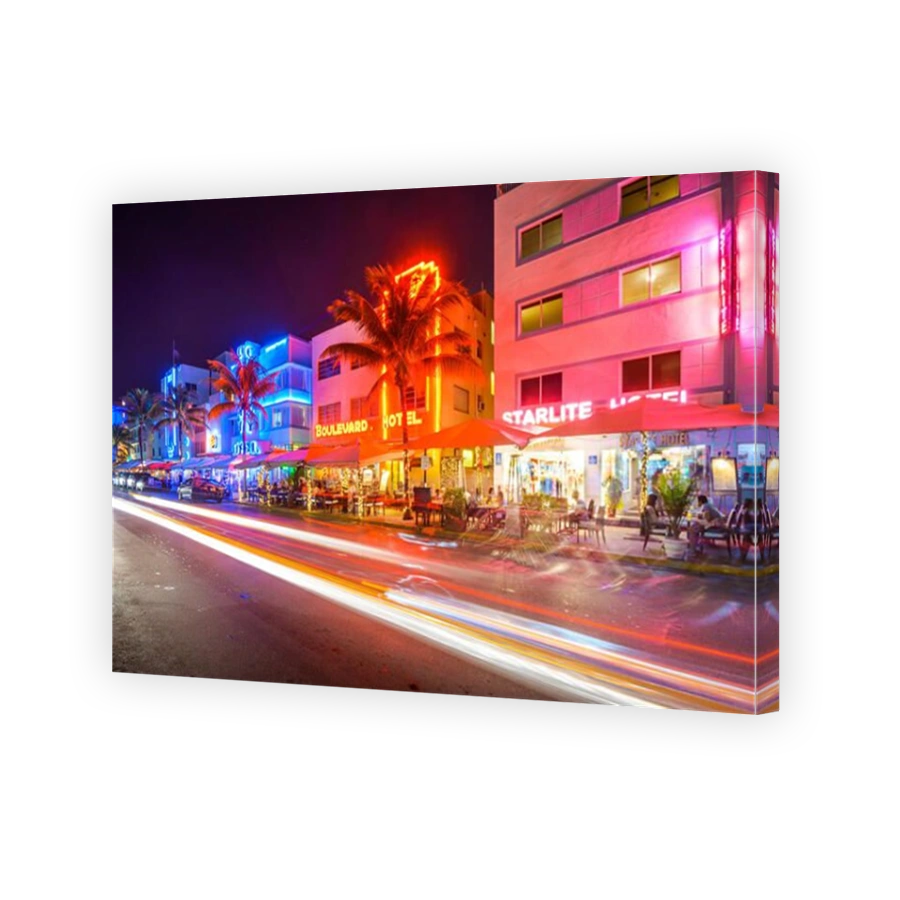 MIAMI, FLORIDA - JANUARY 6, 2014: Cars speed down Ocean Drive. The road is the main thoroughfare through South Beach.