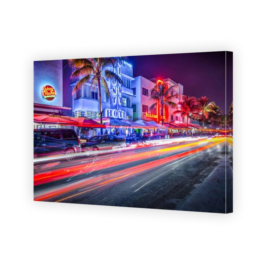 MIAMI, FLORIDA - JANUARY 6, 2014: Cars speed down Ocean Drive. The road is the main thoroughfare through South Beach.