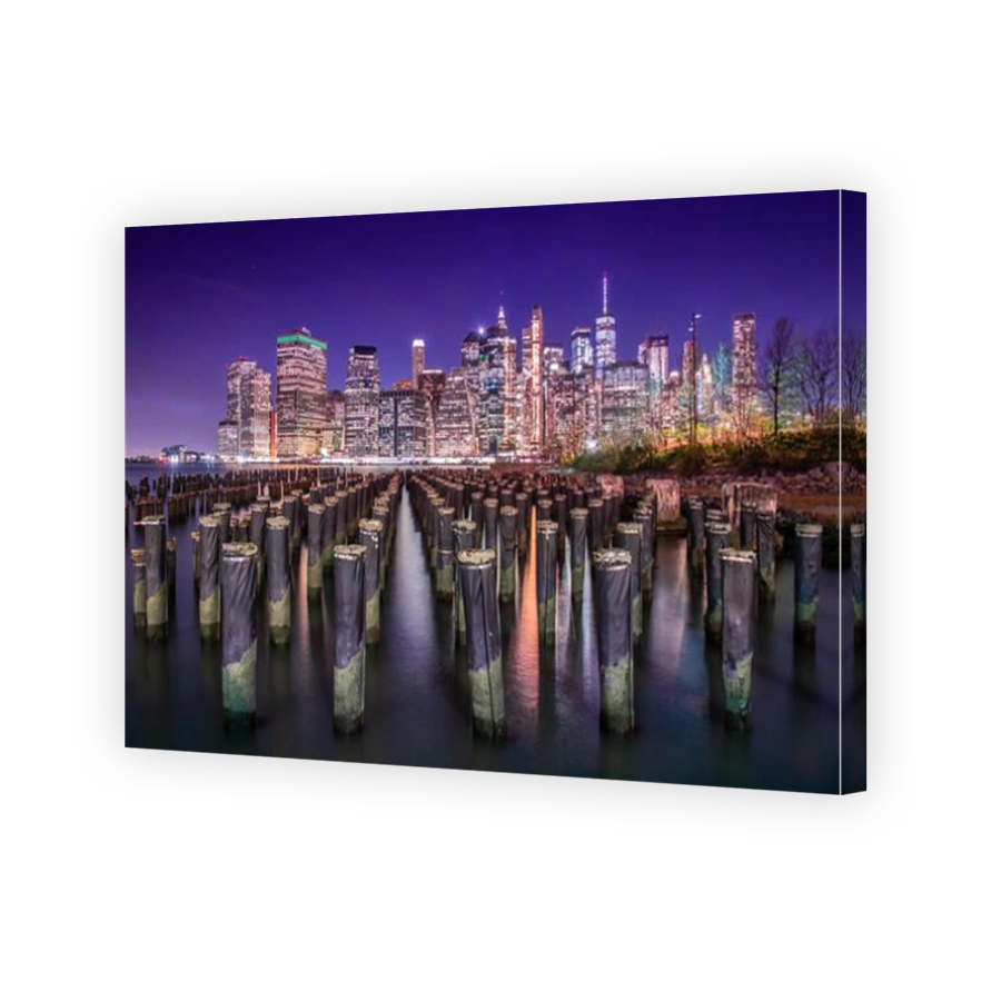 Shot of Manhattan and its skyline at night from the docks of Brooklyn. New York City, USA