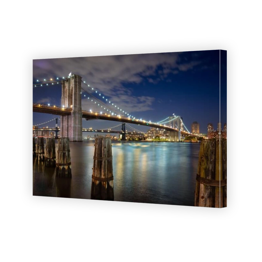 Evening view of the Brooklyn Bridge and Manhattan Bridge and wood pilings. View of East River and Dumbo in Brooklyn, New York City