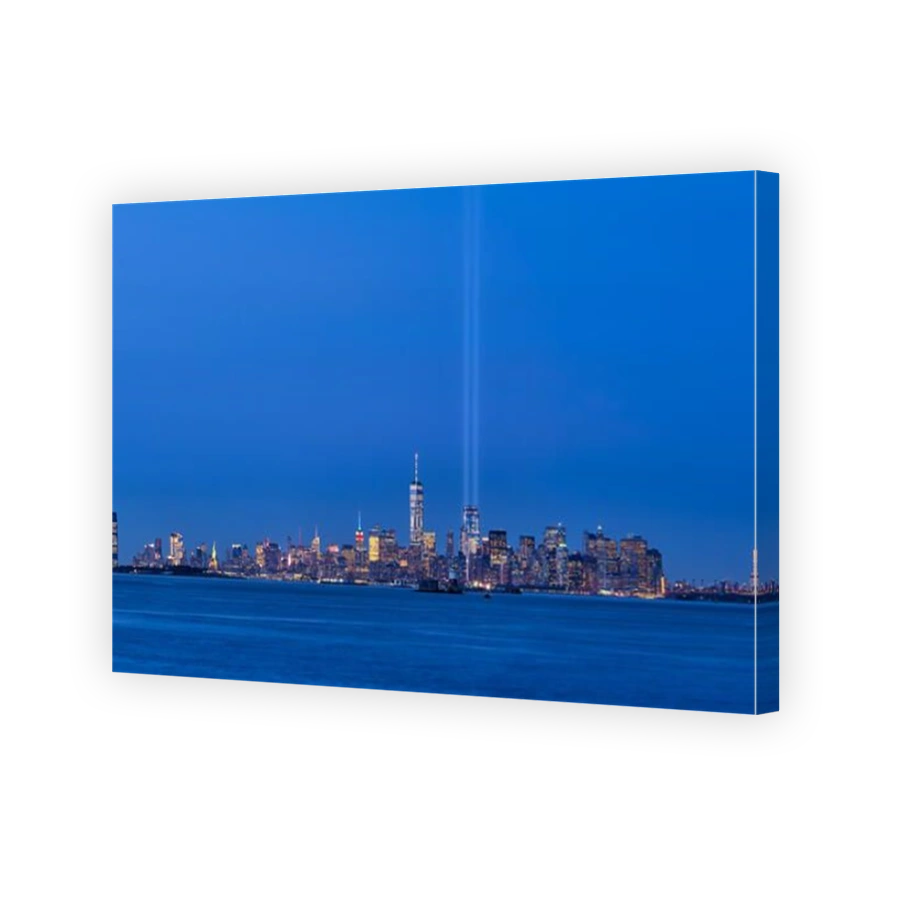 New York City skyline with skyscrapers and two beams of the Tribute in Light. Lower Manhattan, Financial District, New York Harbor