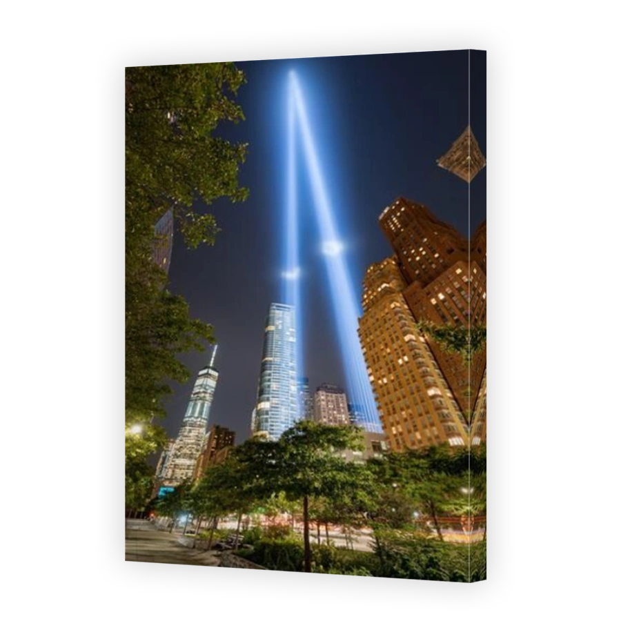 New York City commemoration of September 11. Tribute in Light. Two vertical columns of light rising between the skyscrapers of Lower Manhattan