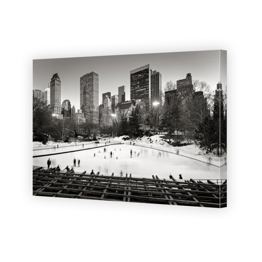 Central Park Ice skating, Wollman Rink, with Midtown Manhattan skyscrapers at twilight in Black & White. New York City