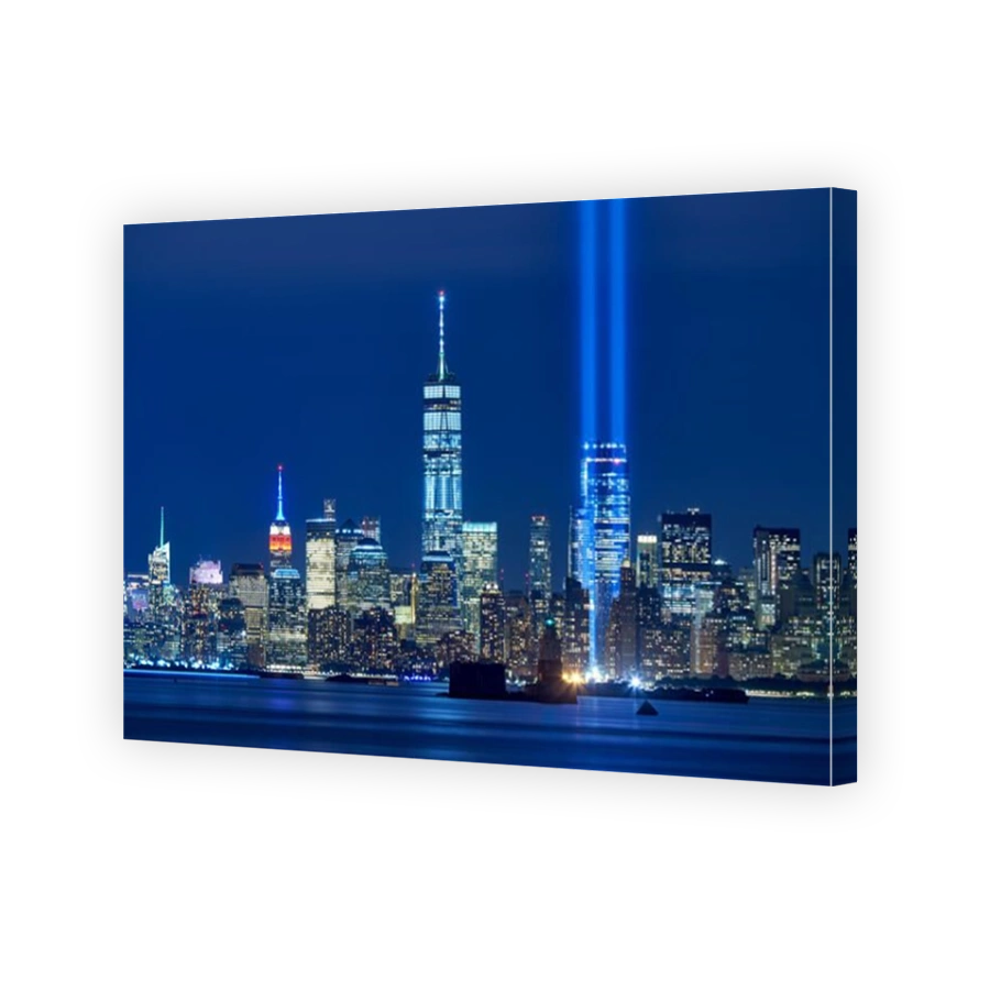 The two beams of the Tribute in Light with skycrapers of Financial District at night. Lower Manhattan, New York City