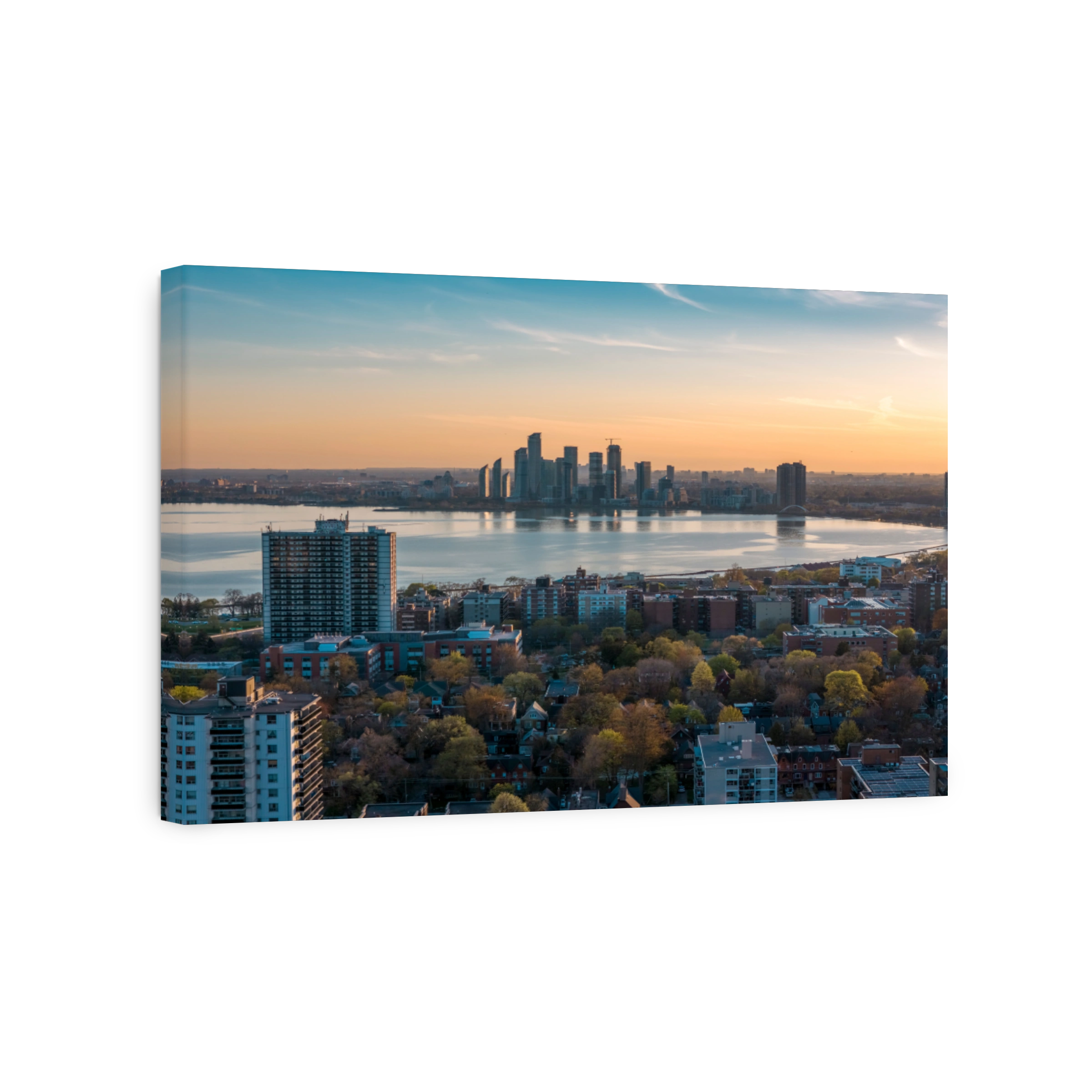 Toronto skyline at sunset with Lake Ontario.