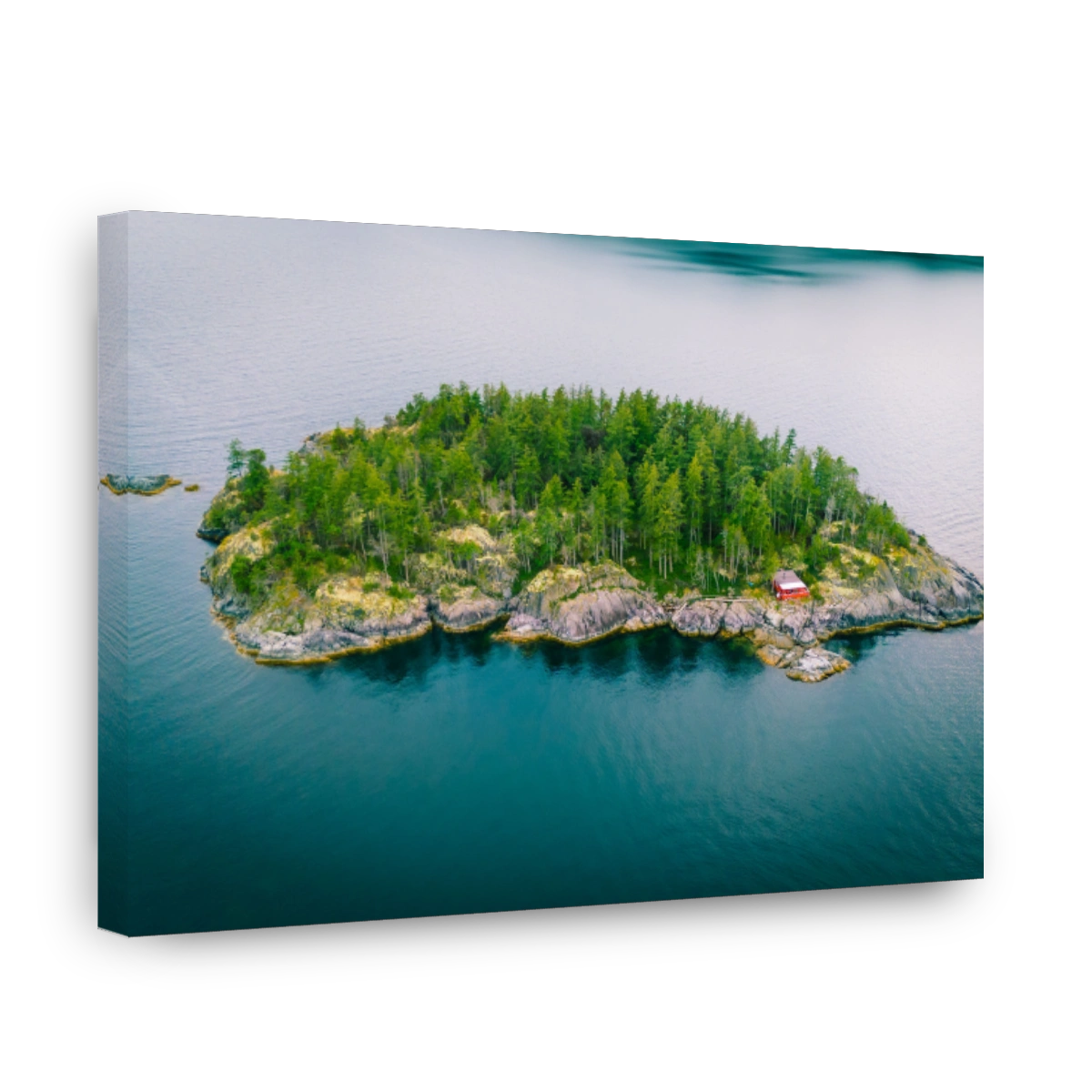 Aerial view of a green island with a red cabin.