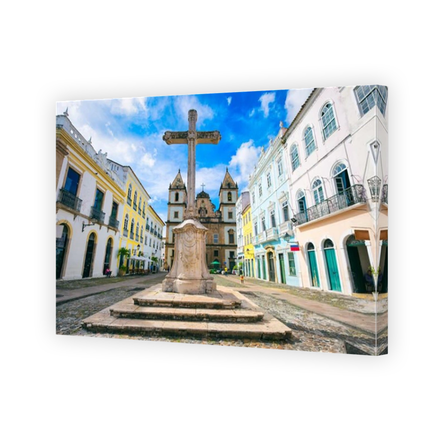 Bright view of the historic tourist district of Pelourinho, Salvador, Brazil, with colonial Saint Francis Christian stone cross in Anchieta Plaza