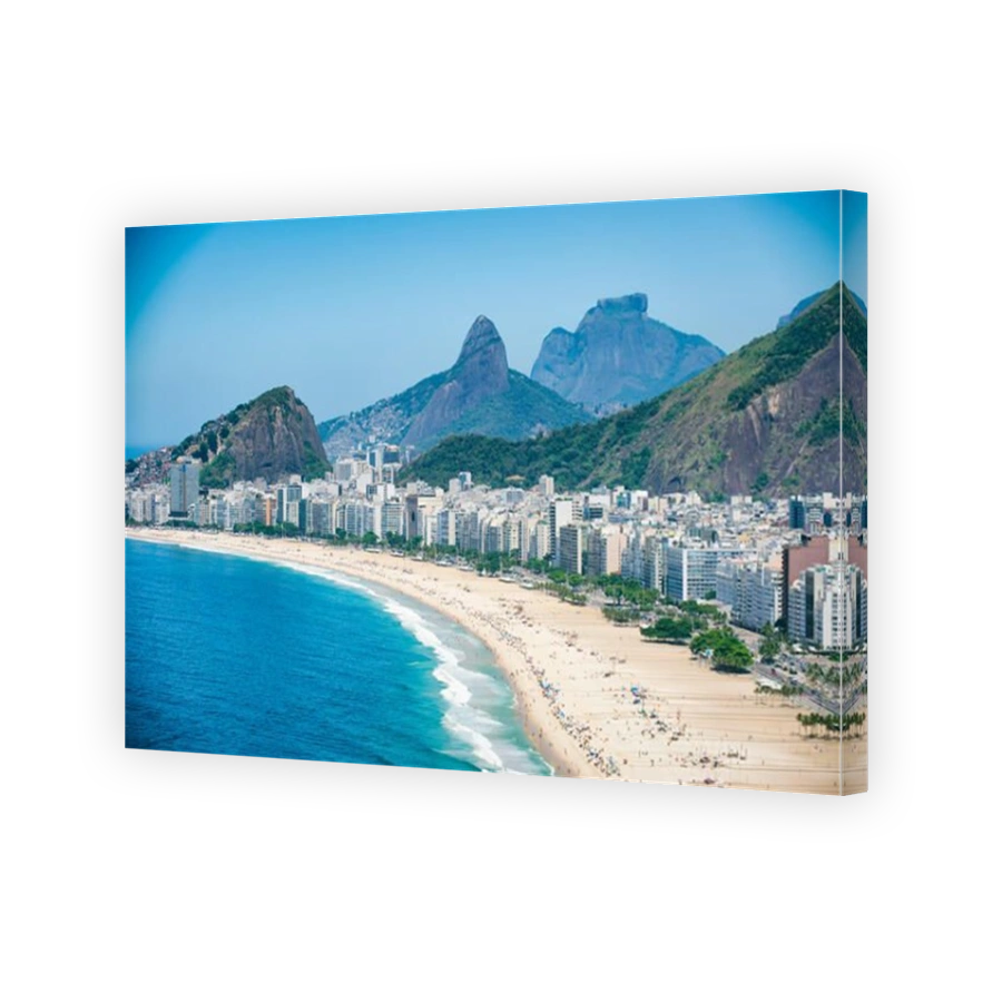 Bright scenic view of the Rio de Janeiro, Brazil skyline overlooking the shore of Copacabana Beach and dramatic mountains in the background
