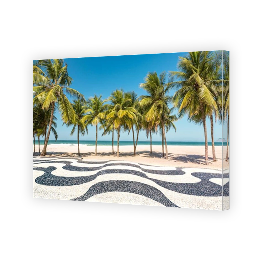 Palm trees and the iconic Copacabana beach mosaic sidewalk, in Rio de Janeiro, Brazil.
