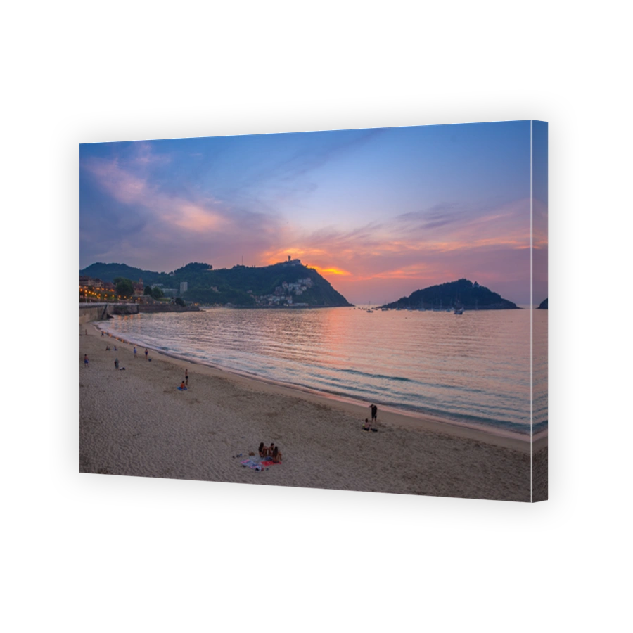 Nice beach with the old town of San Sebastian, Spain at gorgeous sunset