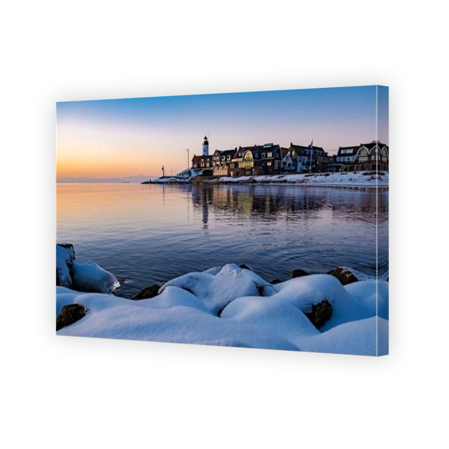 Urk Netherlands lighthouse during winter with snow covered coastline, Urk view at the lighthouse snowy landscape winter weather in Holland. Europe