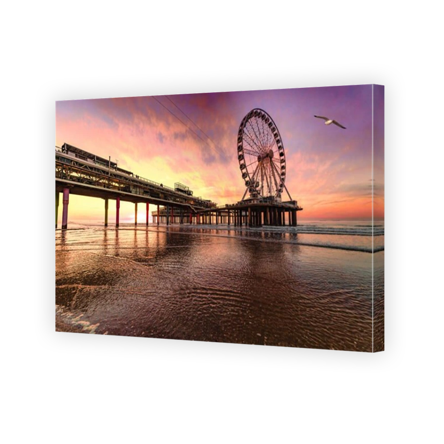 Landscape of a sunset at the beach and the pier of Scheveningen with nobody, no tourists, The Hague, Netherlands