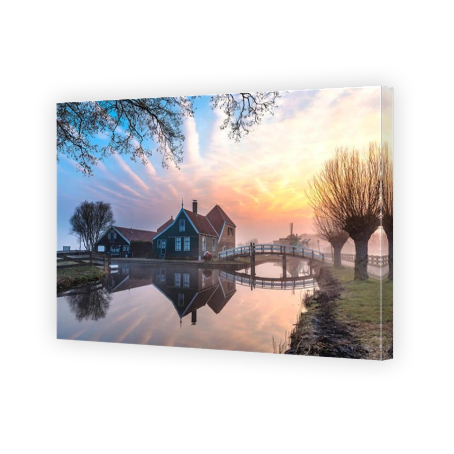 Beautiful and typical Dutch wooden houses architecture mirrored on the calm canal of Zaanse Schans located at the North of Amsterdam, Netherlands