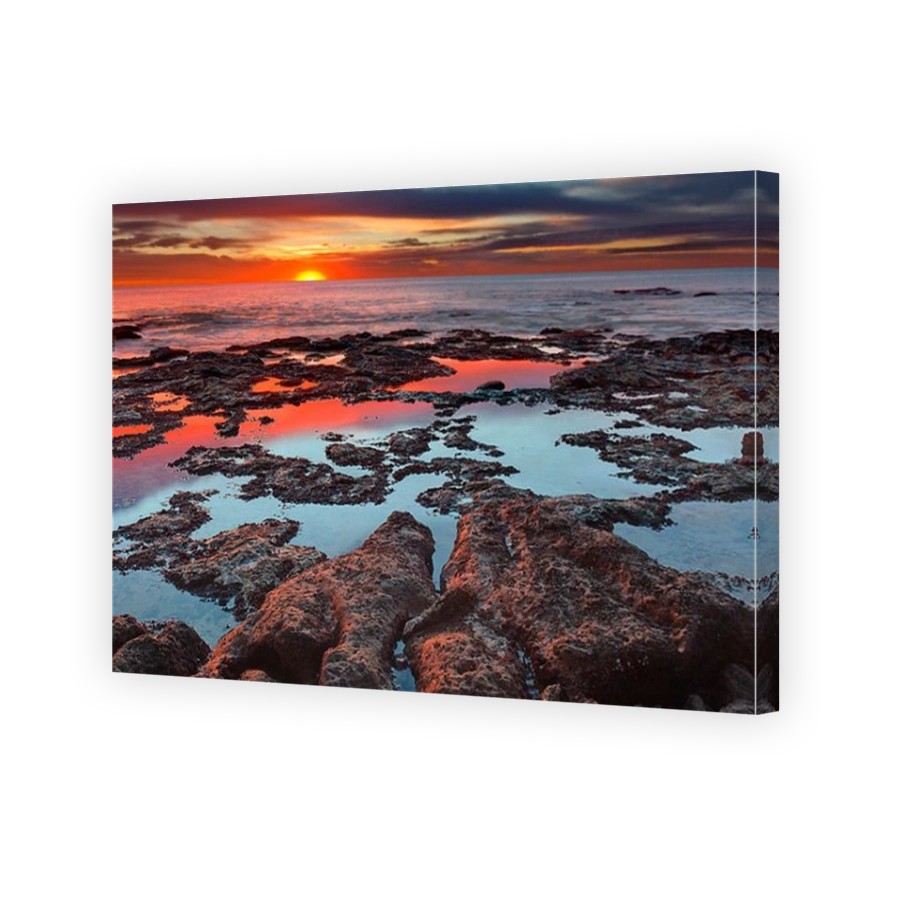 Tidal pools reflecting the sunrise colors at the southern hemisphere autumn equinox, Miramar, Argentina.