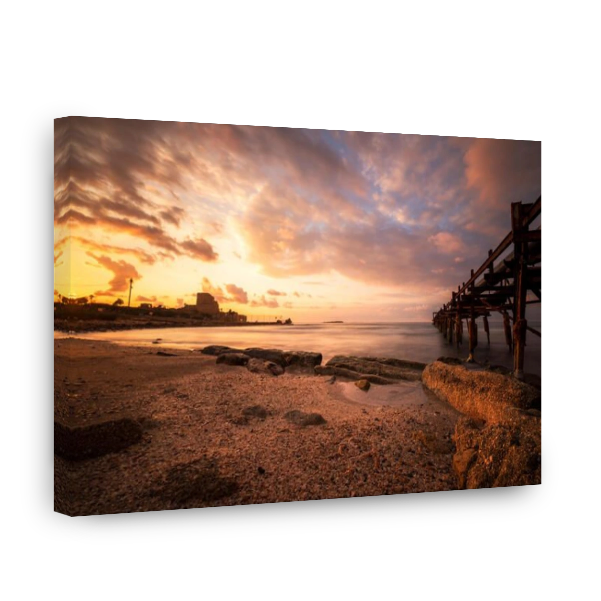 sunset at Atlit beach with a old woden pier, Israel