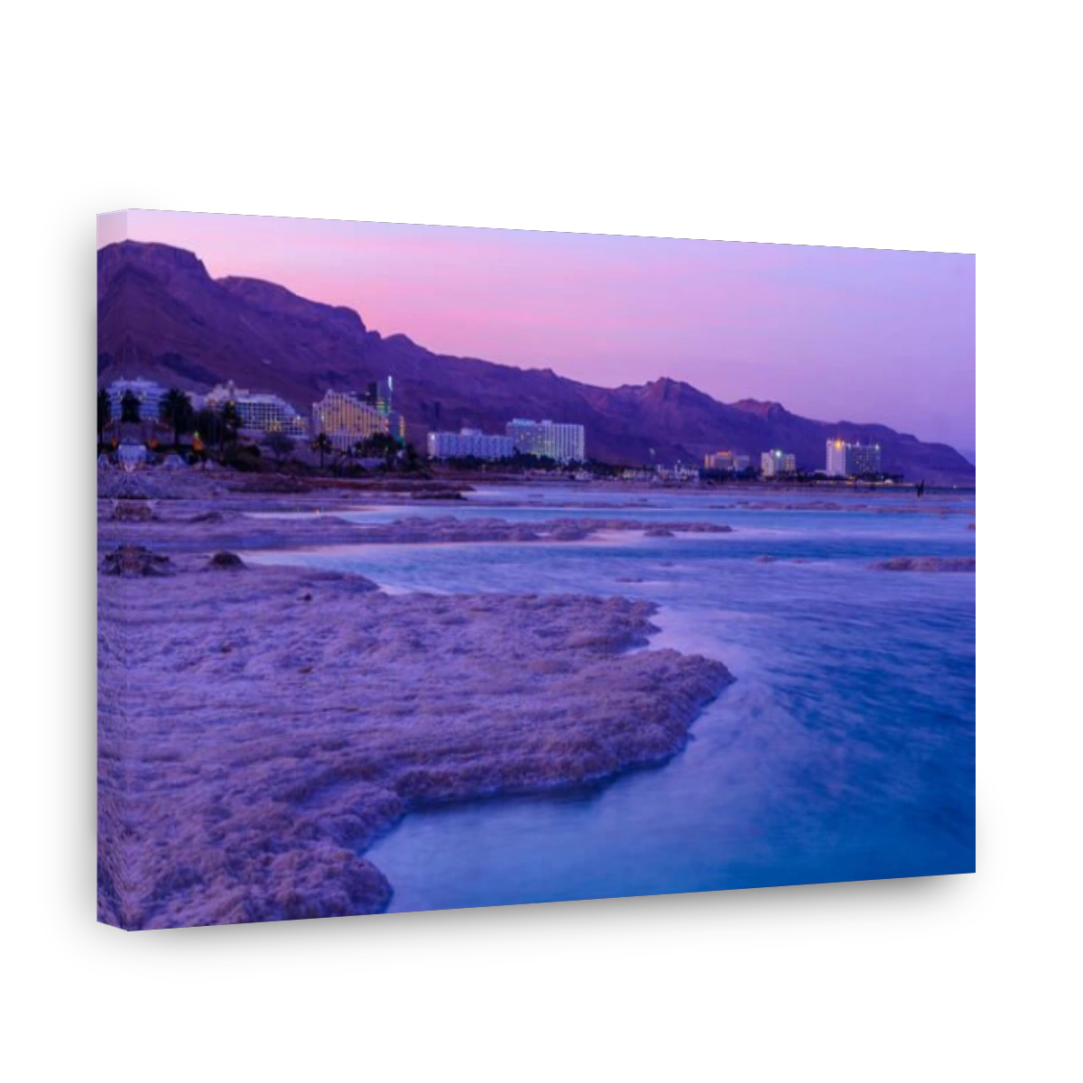 EIN BOKEK, ISRAEL - MARCH 16, 2018: Sunset view of salt formations in the Dead Sea, Ein Bokek resort, and visitors. Southern Israel
