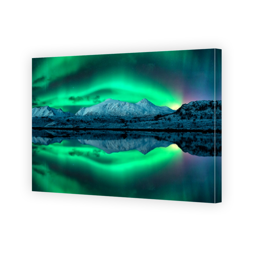 Northern lights over the snowy mountains, sea with reflection in water at night in Lofoten, Norway. Aurora borealis and snow covered rocks. Winter landscape with polar lights and fjord. Starry sky