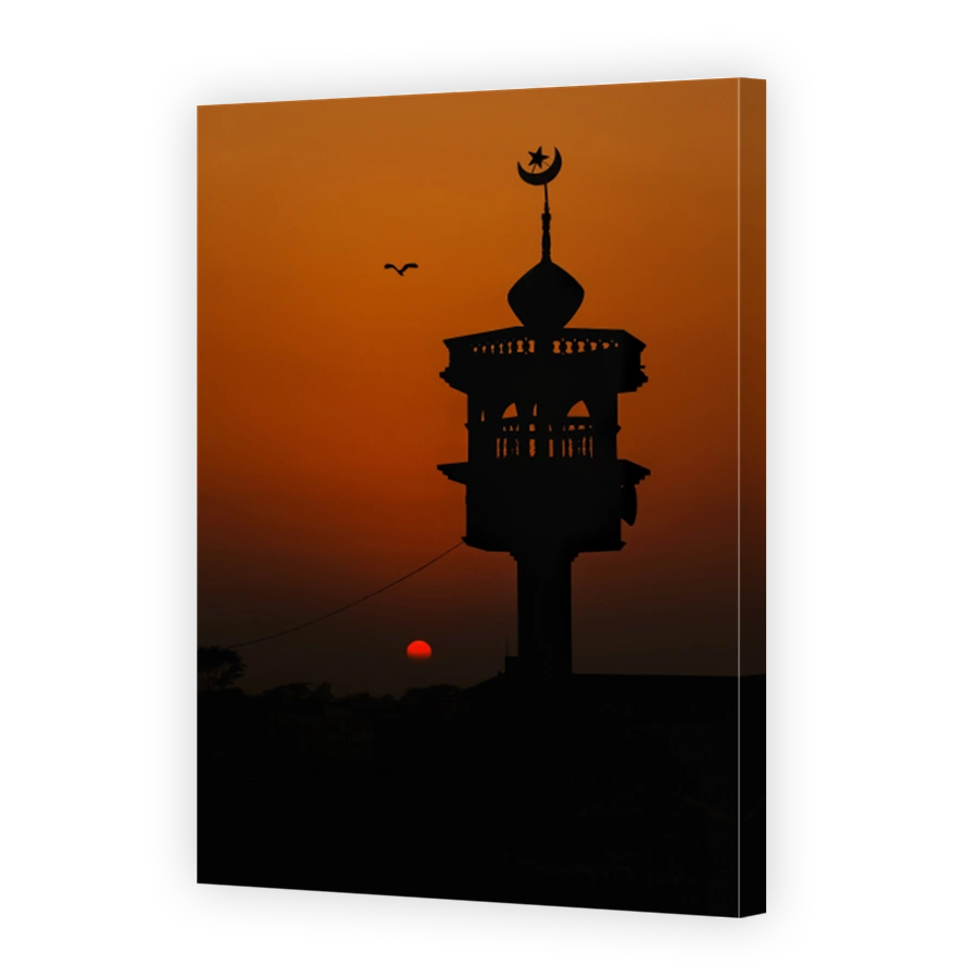 Sunset, a minaret of a mosque and a bird