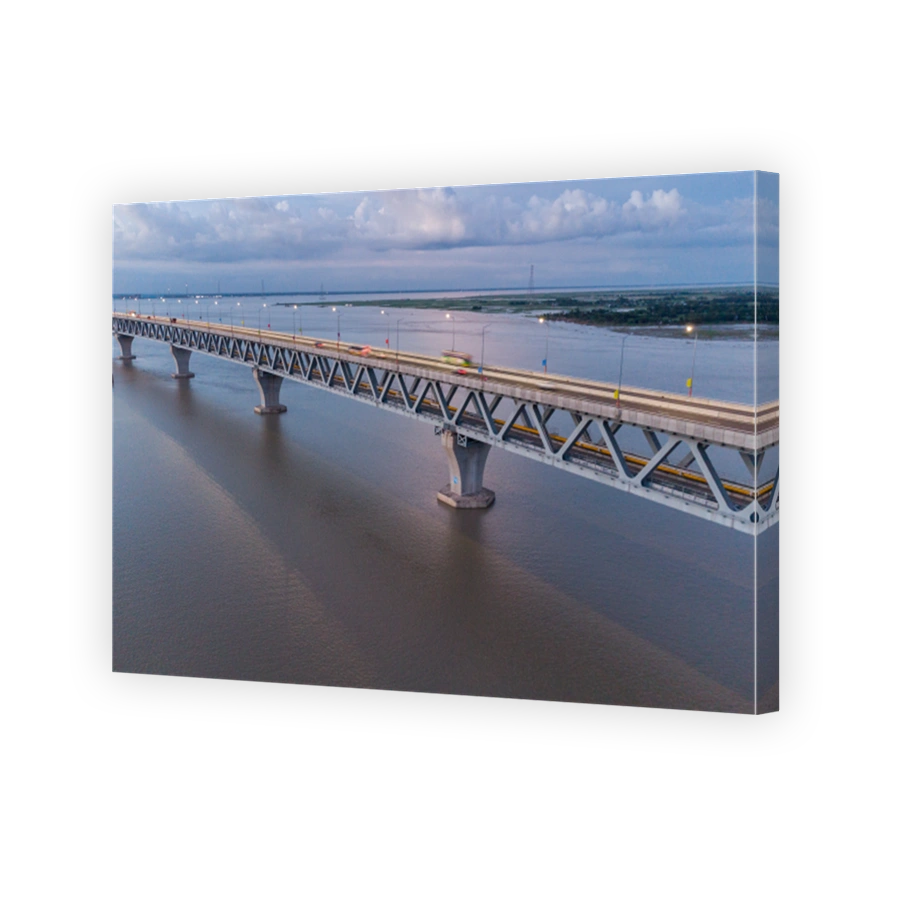 Aerial view of the longest bridge crossing over the Padma River of Bangladesh with the car on the bridge at sunset sky and clouds  - stock photo