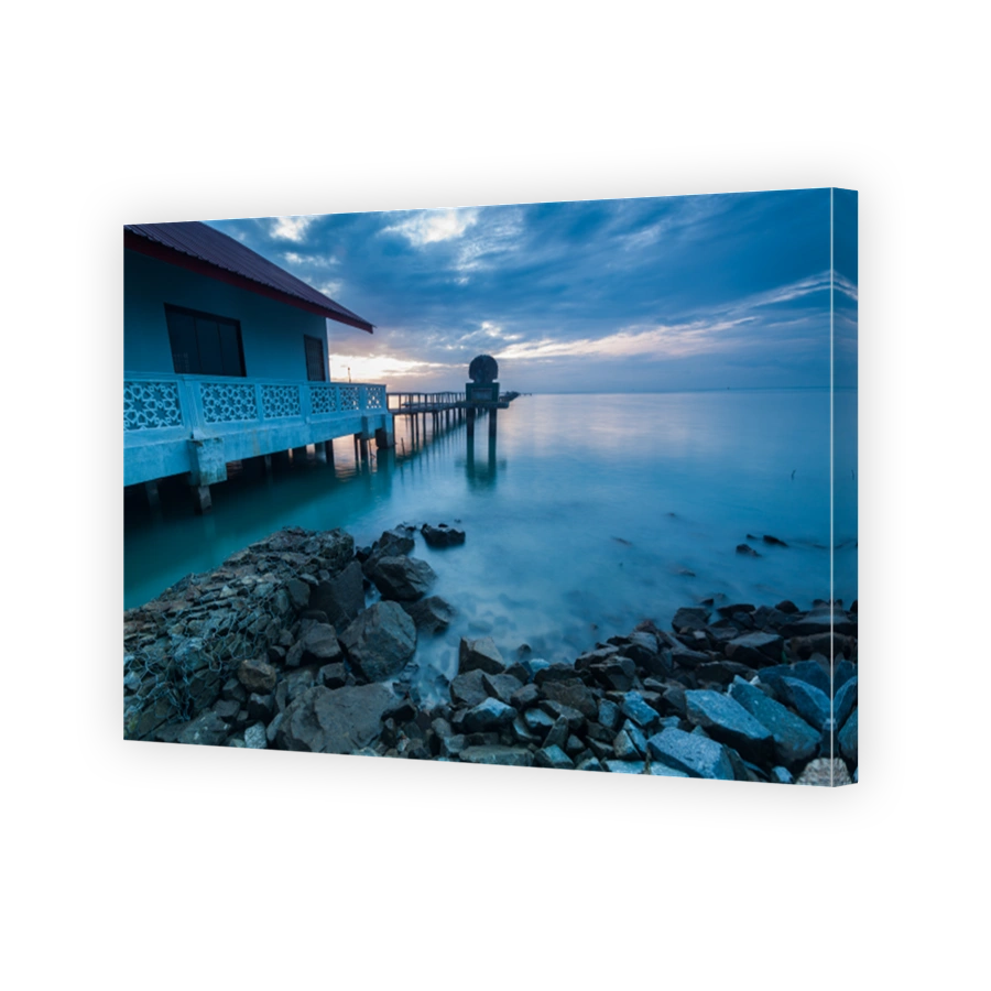 Sunrise by shore with rock foreground for background
