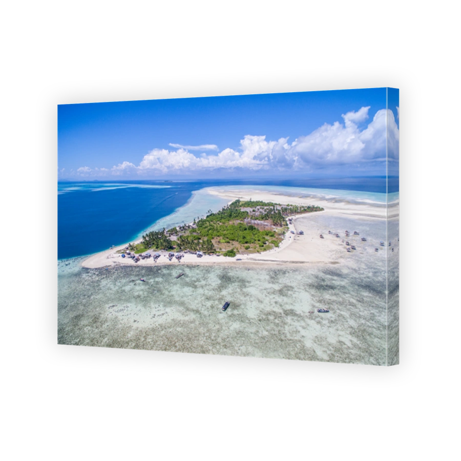 Aerial view of Maiga island panorama, beautiful blue lagoon and coral reef.