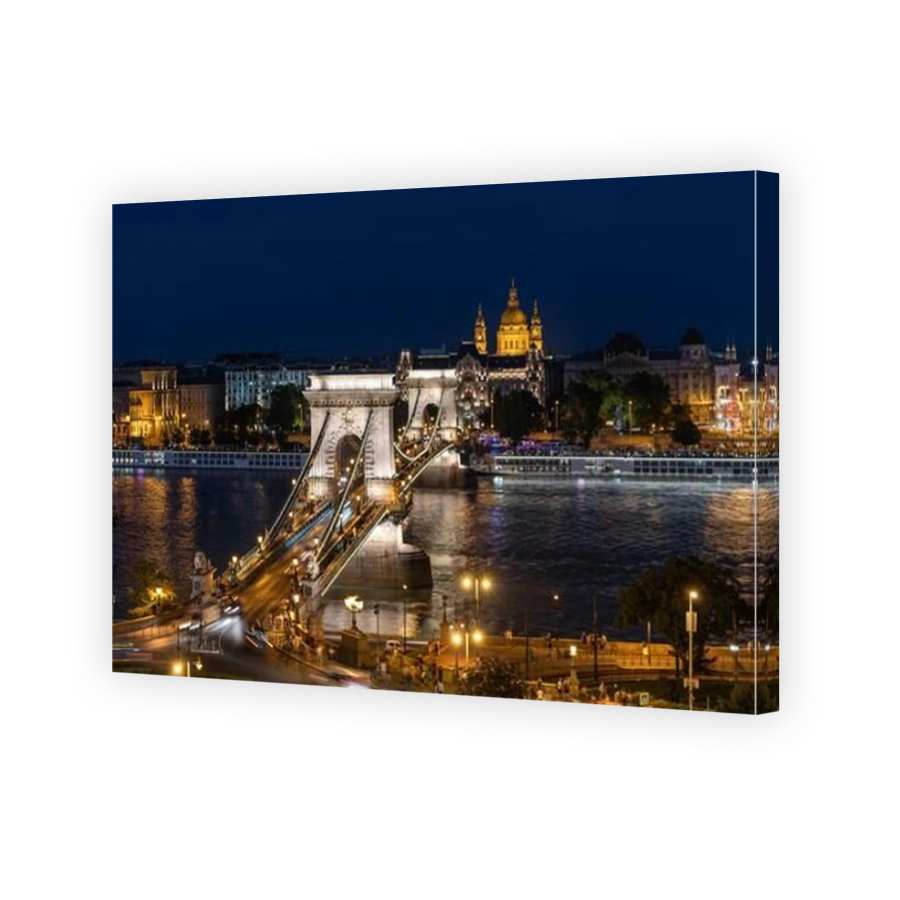 Night view of architectural landmarks Saint Stephens Basilica and Szechenyi Chain Bridge over the Danube River in Budapest, Hungary.