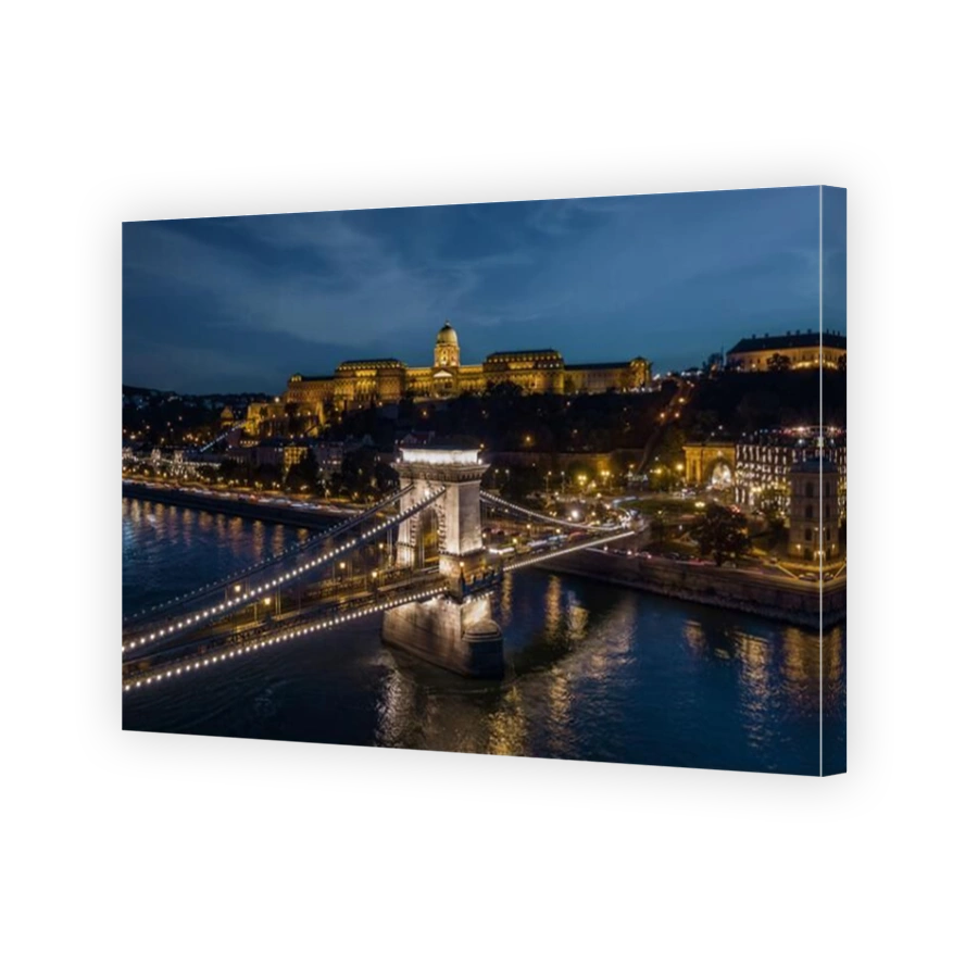 Aerial view of Buda Palace and Szechenyi Chain Bridge over the Danube river at dusk in Budapest, Hungary.