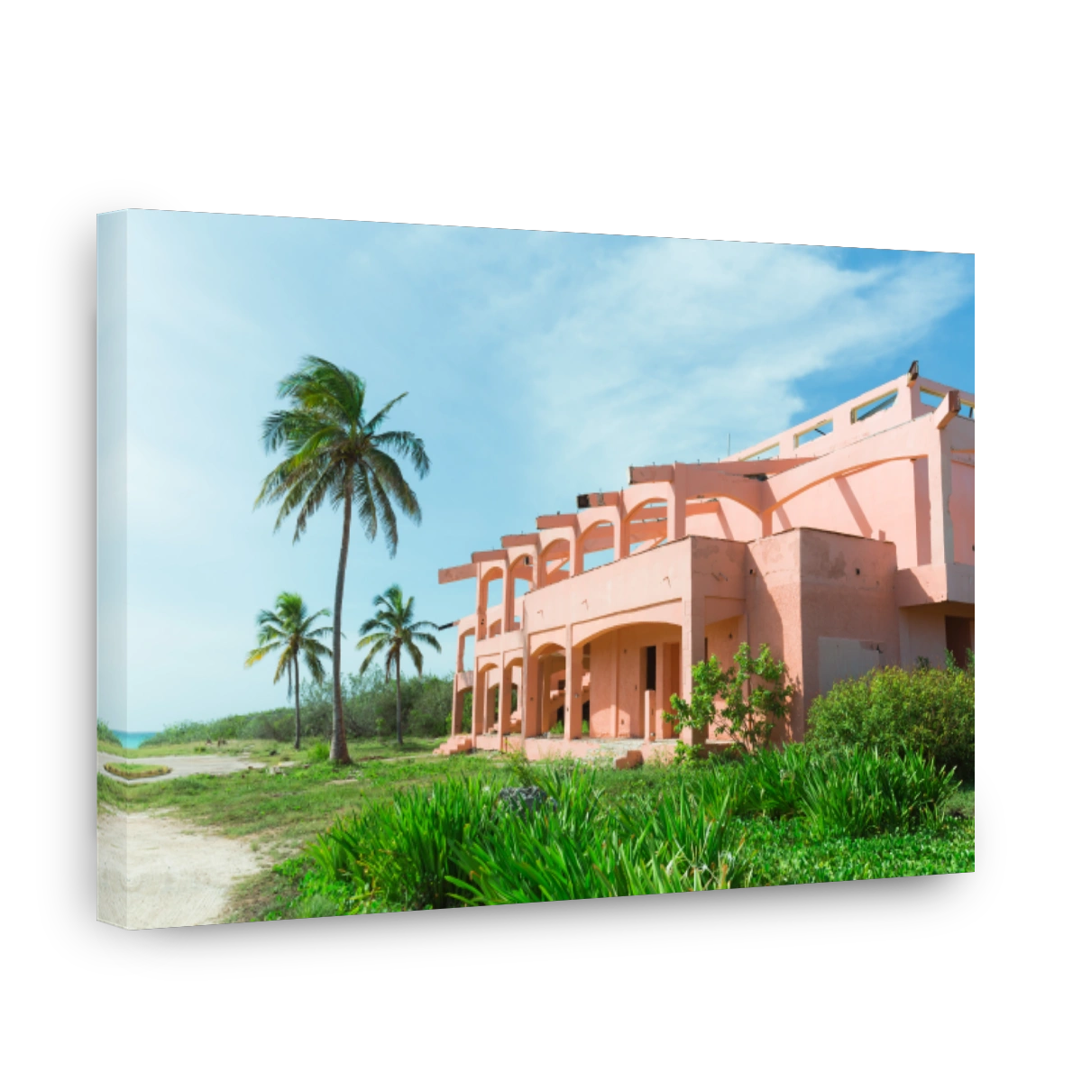 view of an old retro abandoned pink building near the beach, sunny day