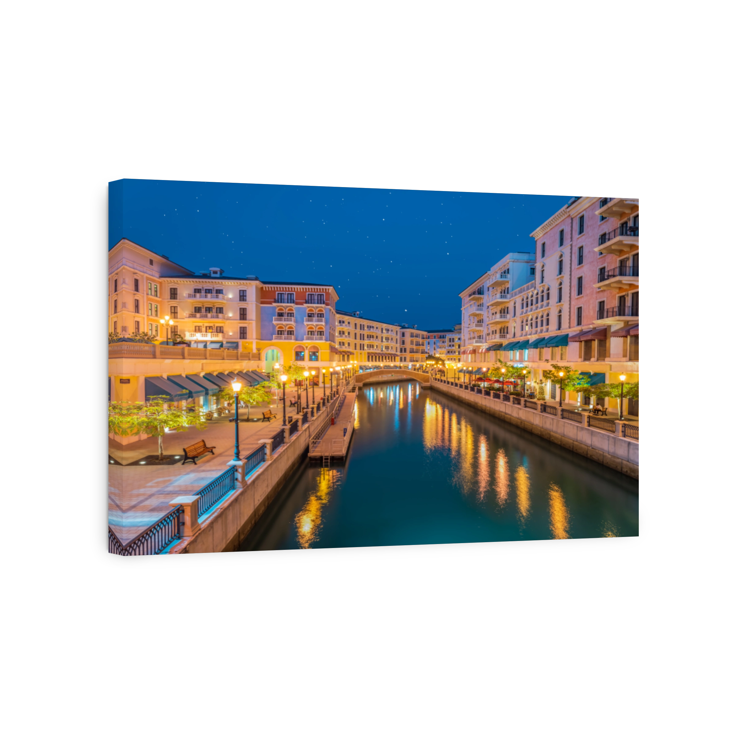 Long exposure shot of Qanat Quartier suburb's canal side colorful buildings in Doha, Qatar