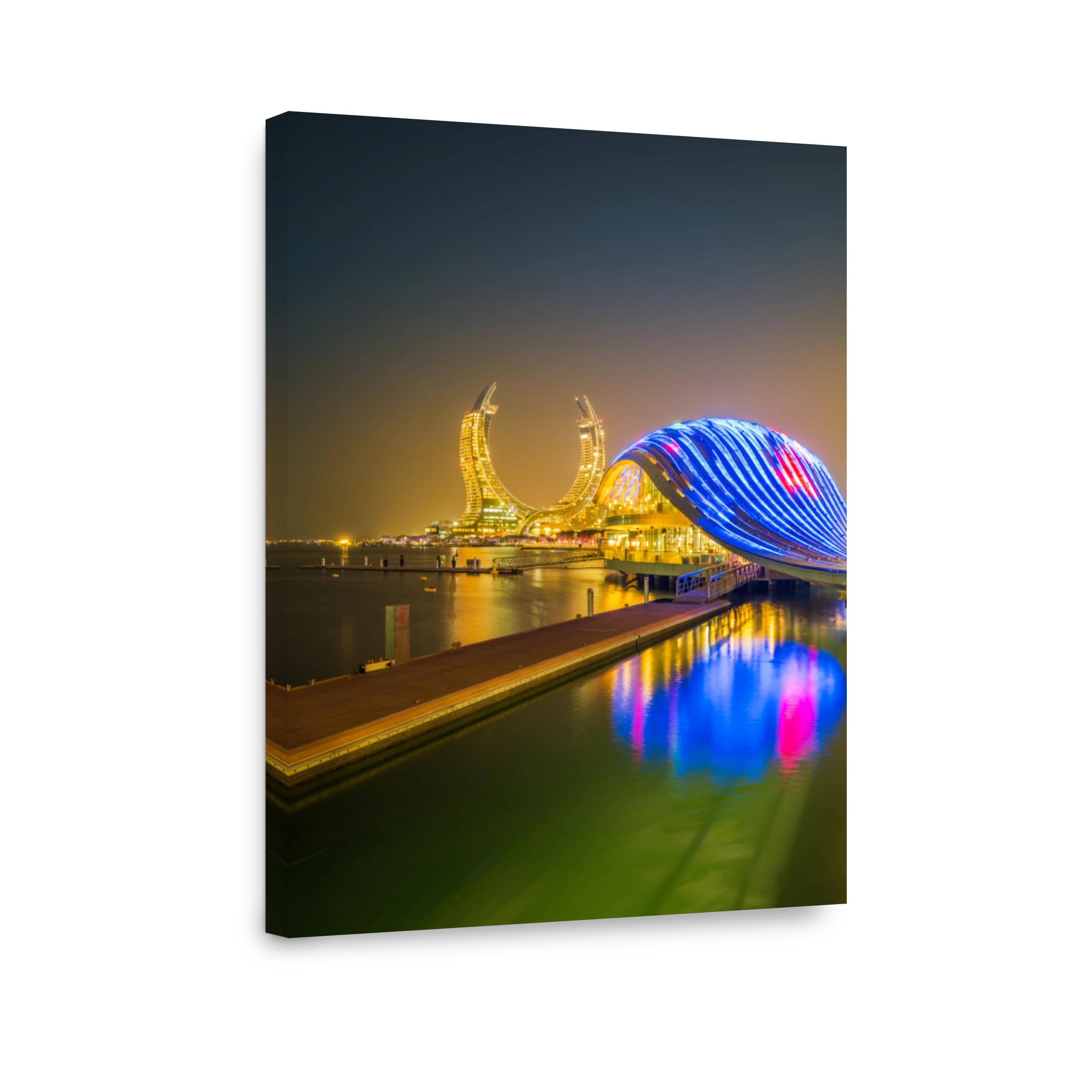 New modern buildings on the beachfront lit up at night in Lusail, Doha, Qatar