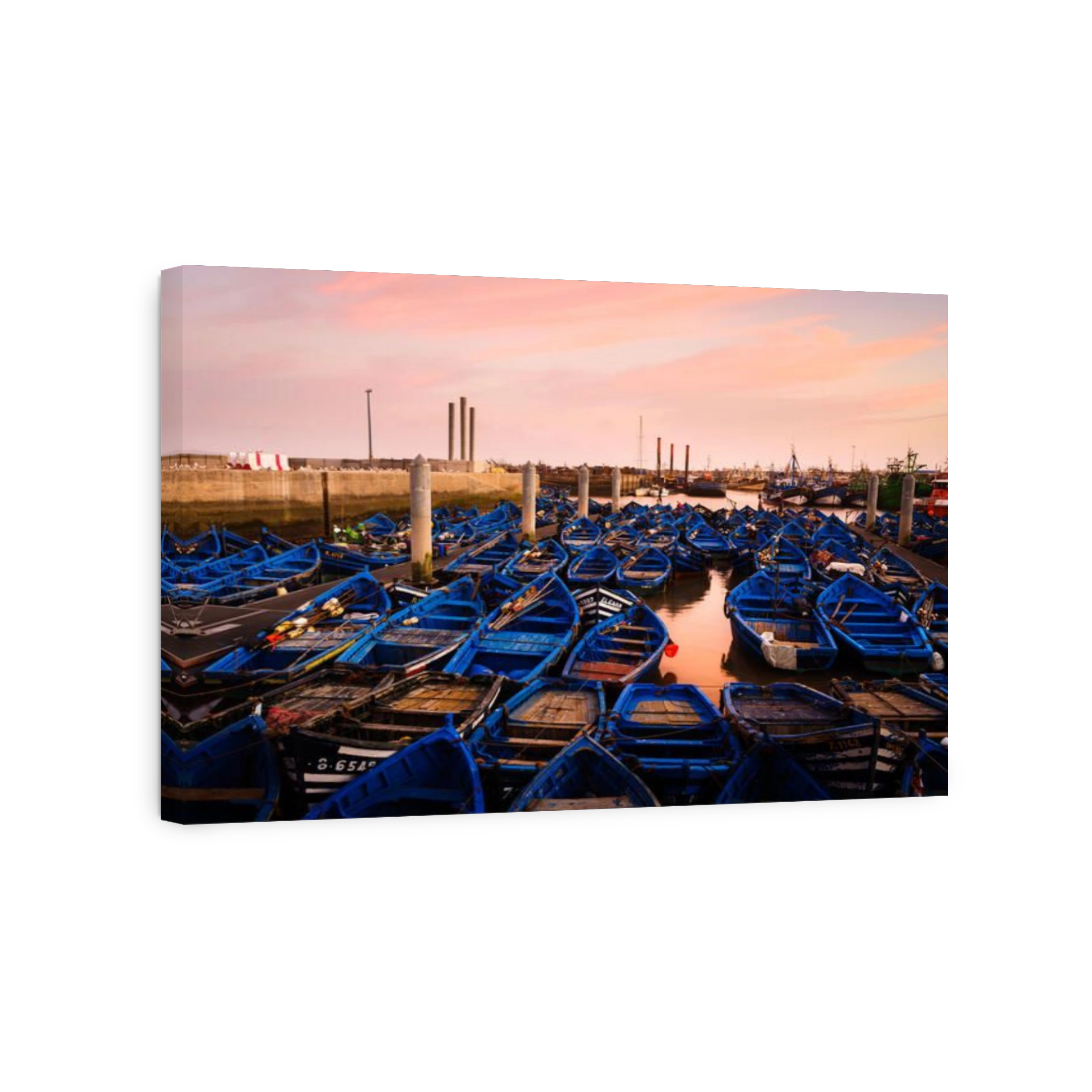ESSAOUIRA, MOROCCO - CIRCA MAY 2018:  Fishing boats over the port of Essaouria at sunset.