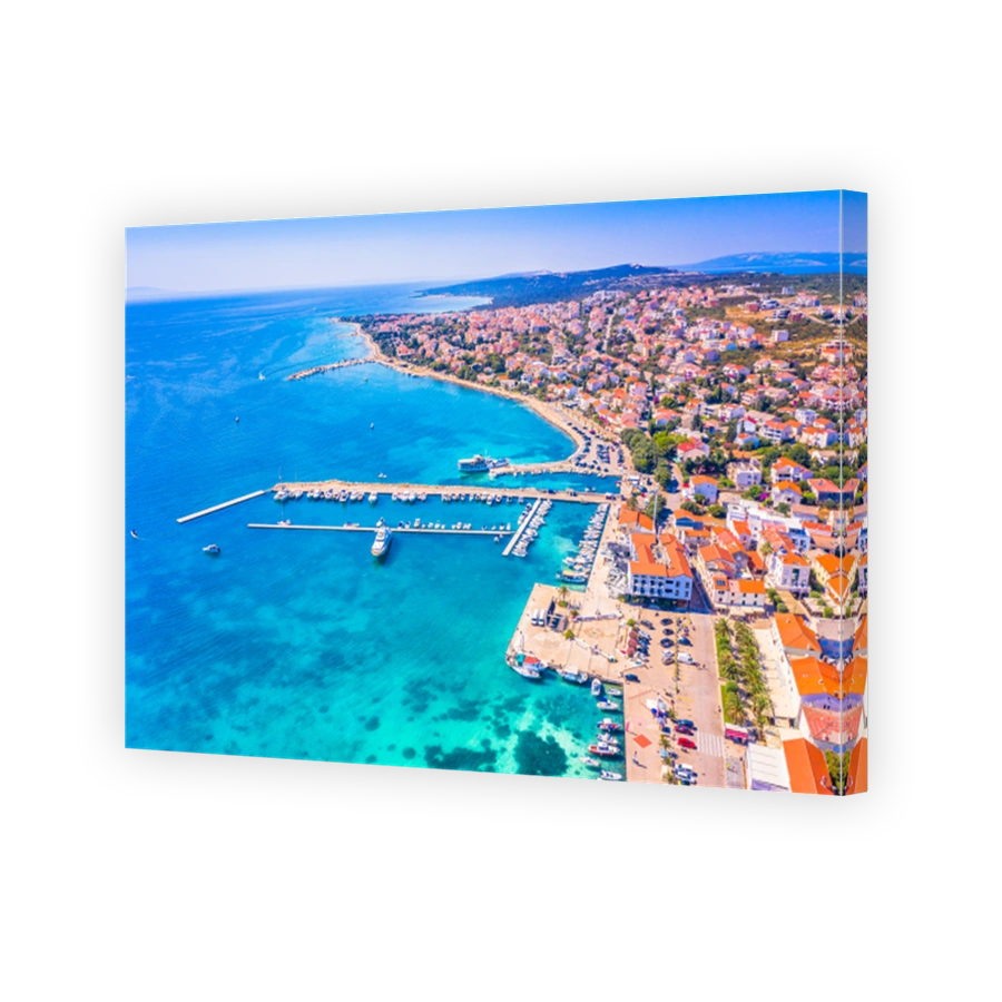 Aerial view of Novalja town on Pag island with marina and coastline