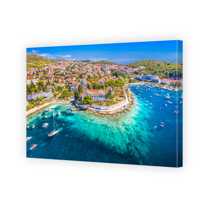 Aerial view of Hvar promenade and harbor under bright summer sun