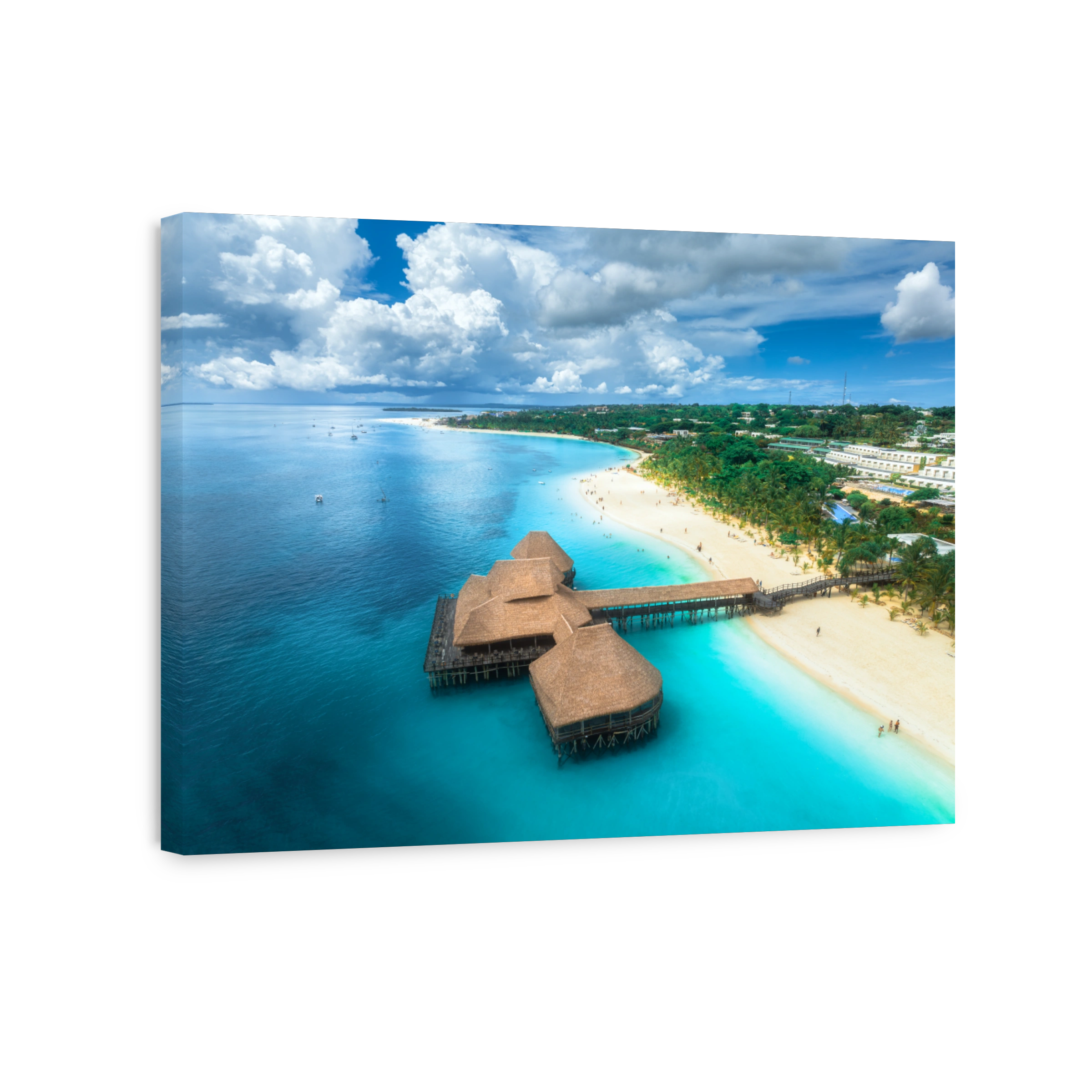 Aerial view of bungalow, white sandy beach, ocean on summer sunny day. Restaurant on the sea. Top drone view of wooden hotel, azure water, palms, sky with clouds. Luxury resort in Kendwa, Zanzibar