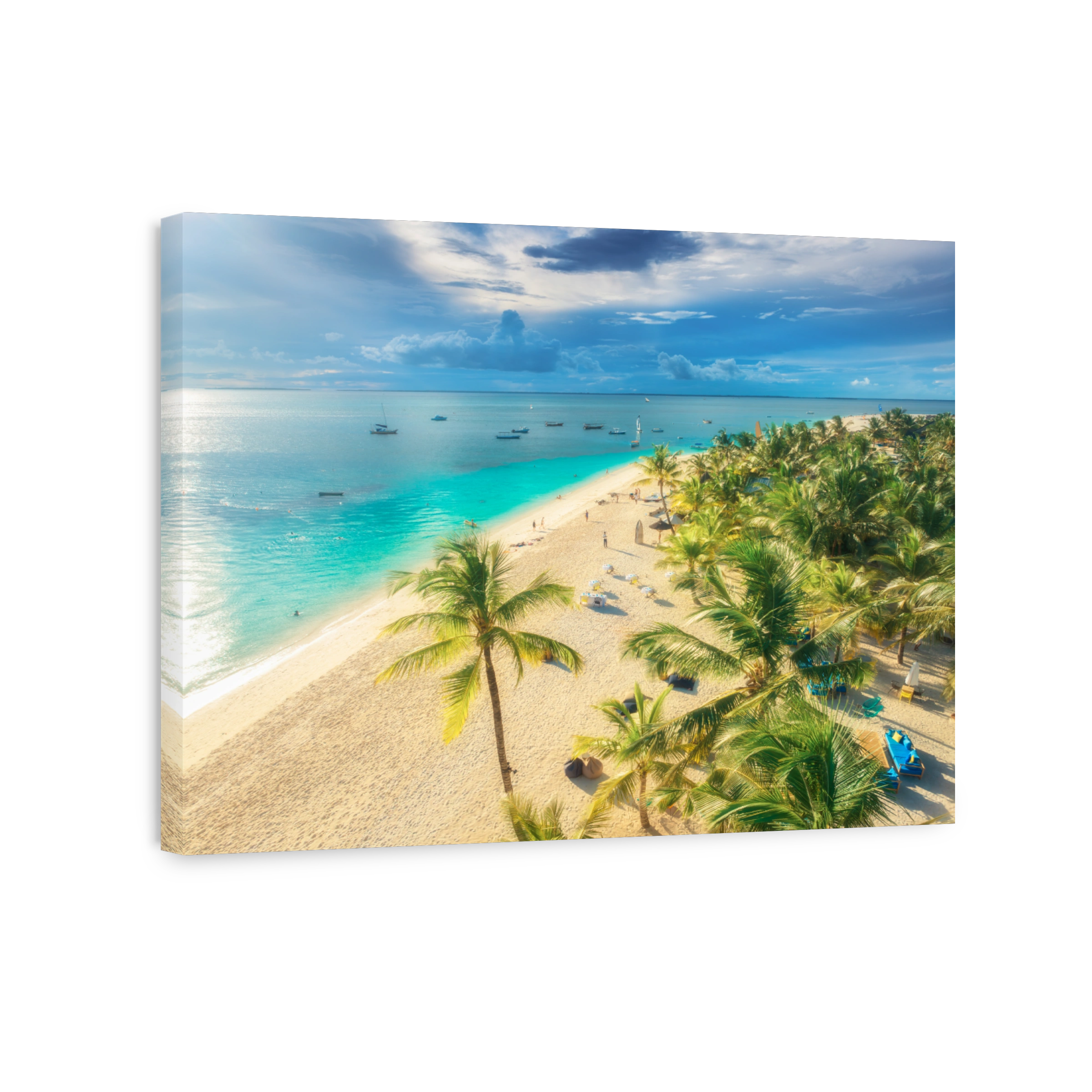 Aerial view of white sandy beach with palms, umbrellas, yachts, boats, blue ocean, sky with clouds at sunset. Summer vacation in Kendwa, Zanzibar island. Tropical landscape. Clear sea. Top view
