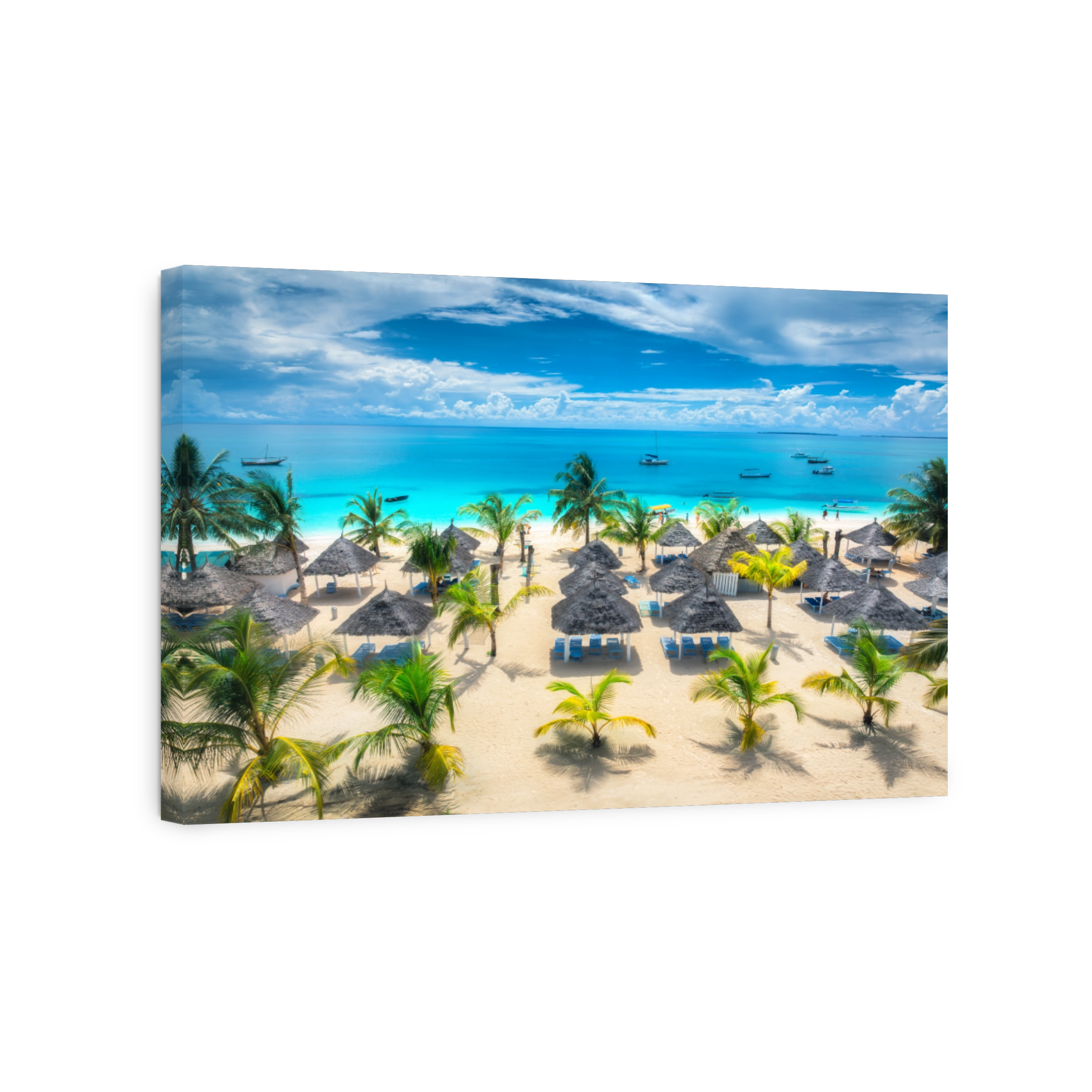 Aerial view of white sandy beach with palm trees, sunbeds, umbrellas, yachts, boats, blue ocean, sky with clouds at sunset. Summer in Kendwa, Zanzibar island. Tropical landscape. Clear sea. Top view