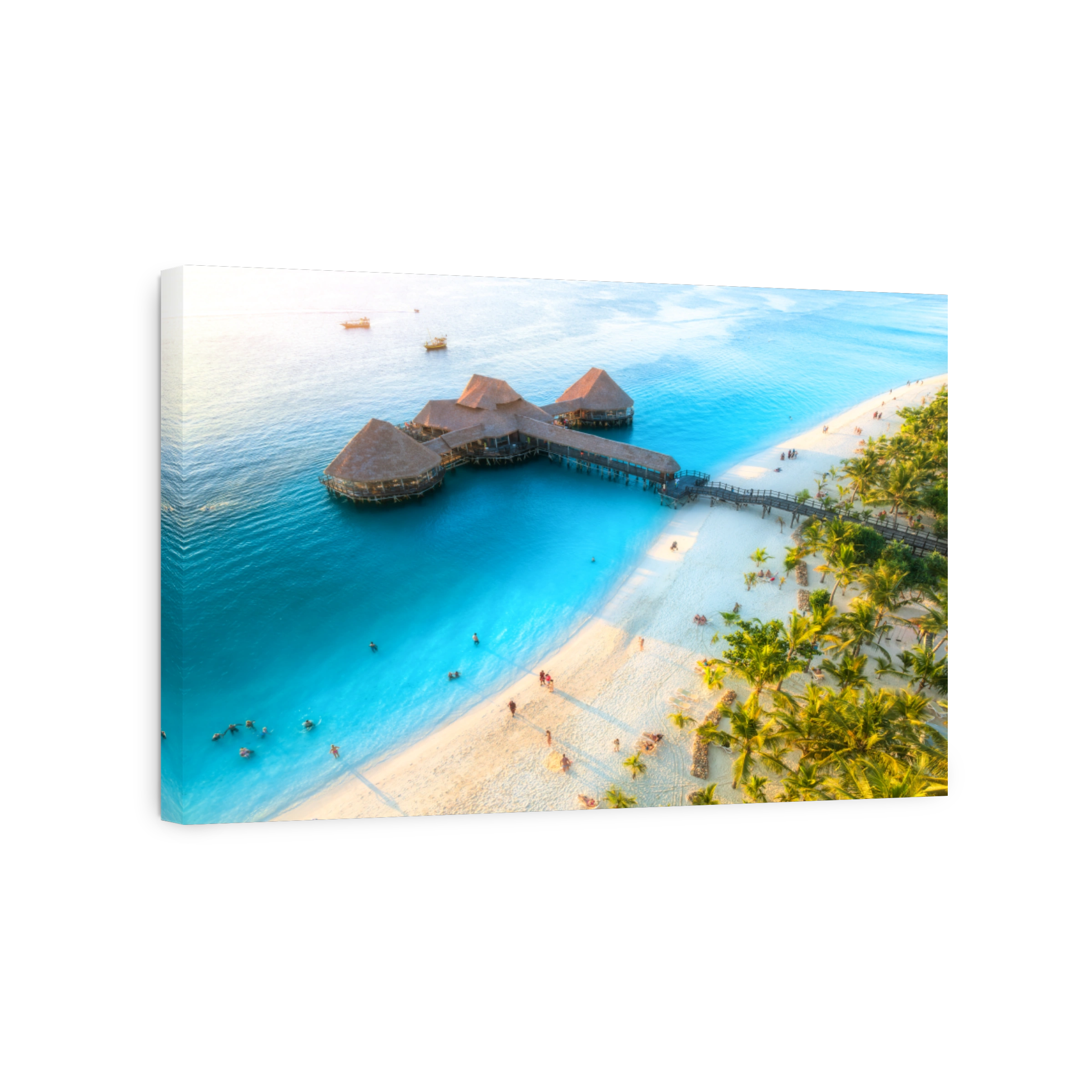 Aerial view of beautiful bungalow in Indian ocean at sunset in summer. Restaurant on the sea. Top view of wooden hotel, palm trees, azure water, white sandy beach. Luxury resort in Kendwa, Zanzibar