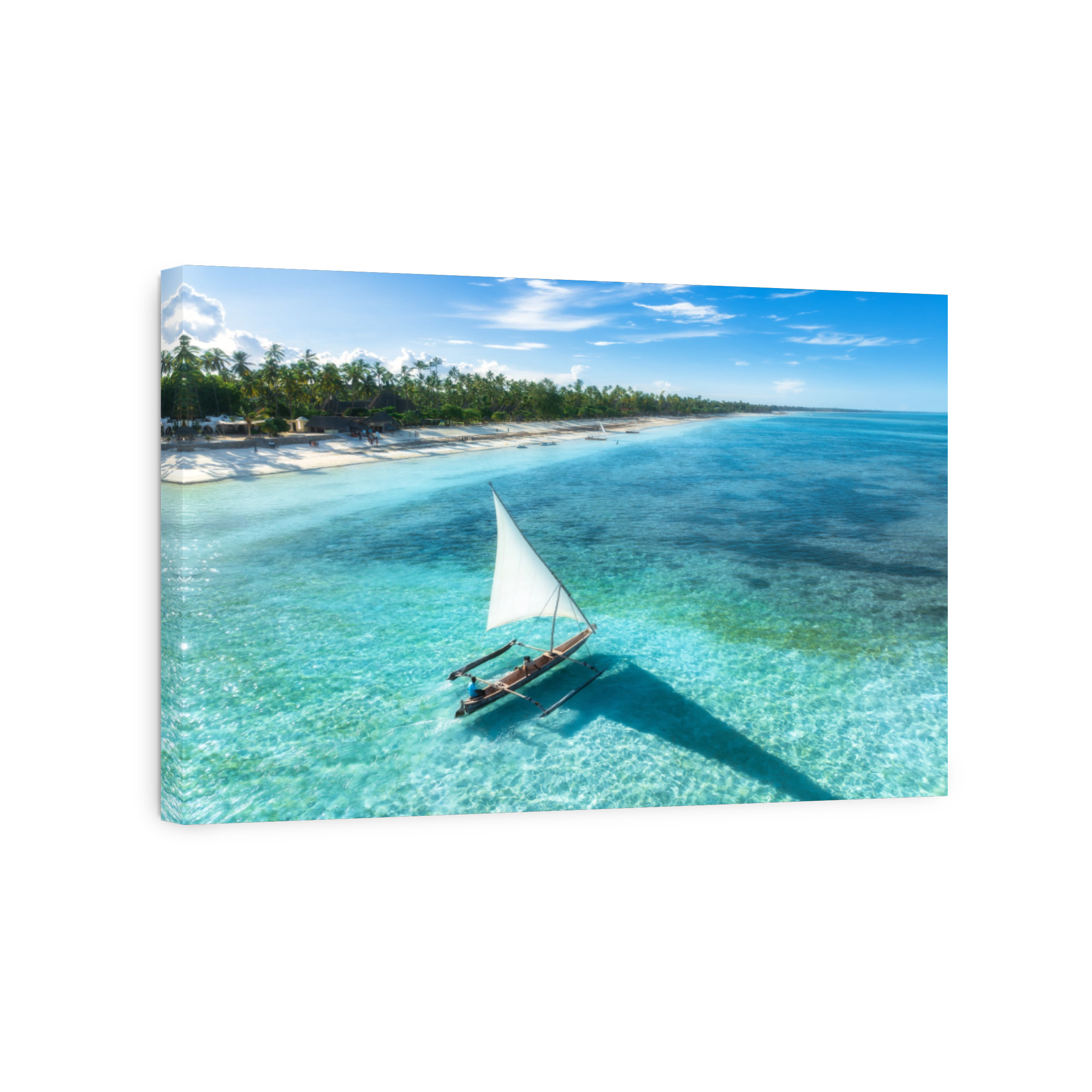 Aerial view of the sailboat on blue sea, empty white sandy beach at sunset. Summer vacation in Zanzibar. Tropical landscape with boat, ocean with clear water, green palms, sky. Top drone view. Exotic