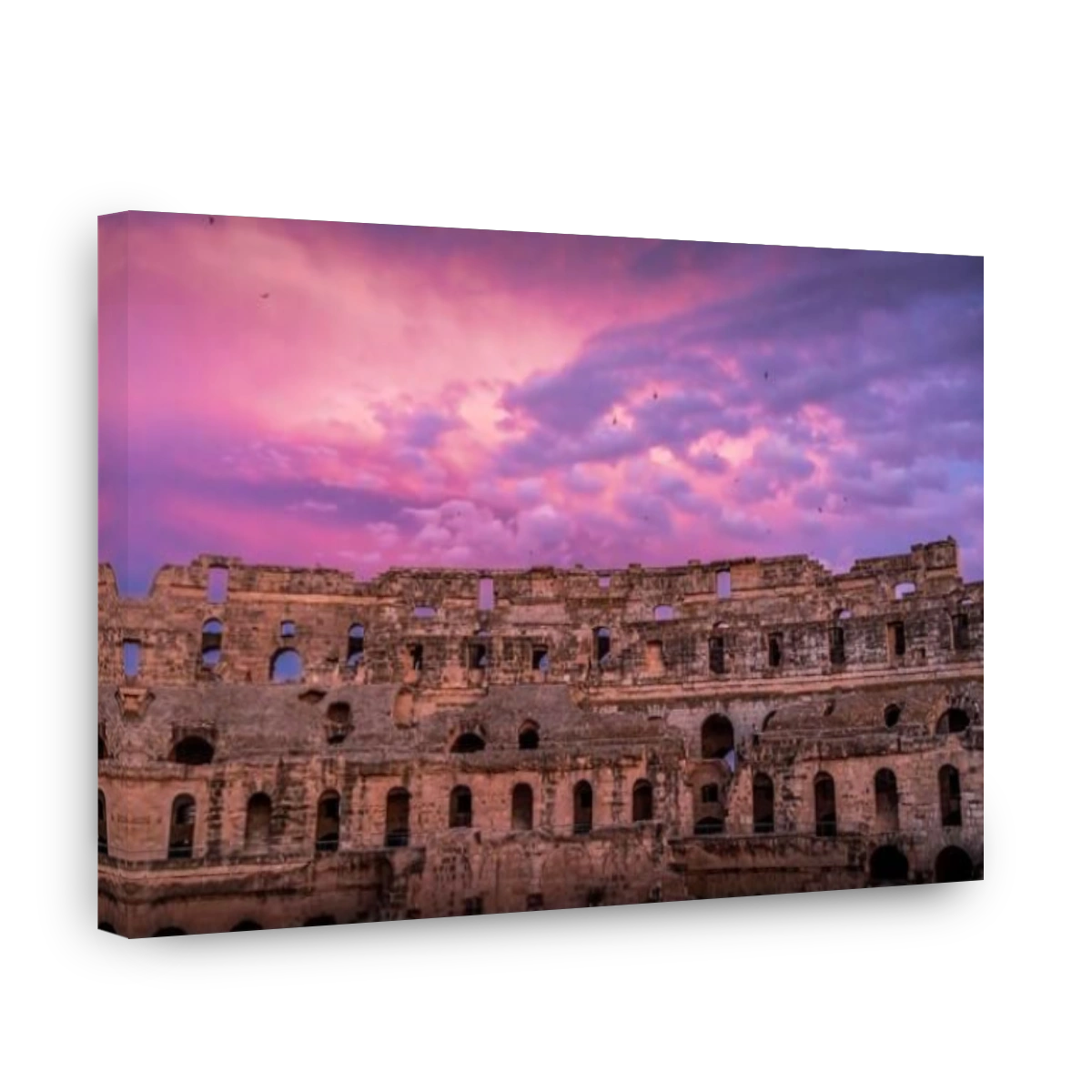 The ruins of Roman Empire amphitheater of El Jem, Tunisia, during the beautiful colorful sunset.