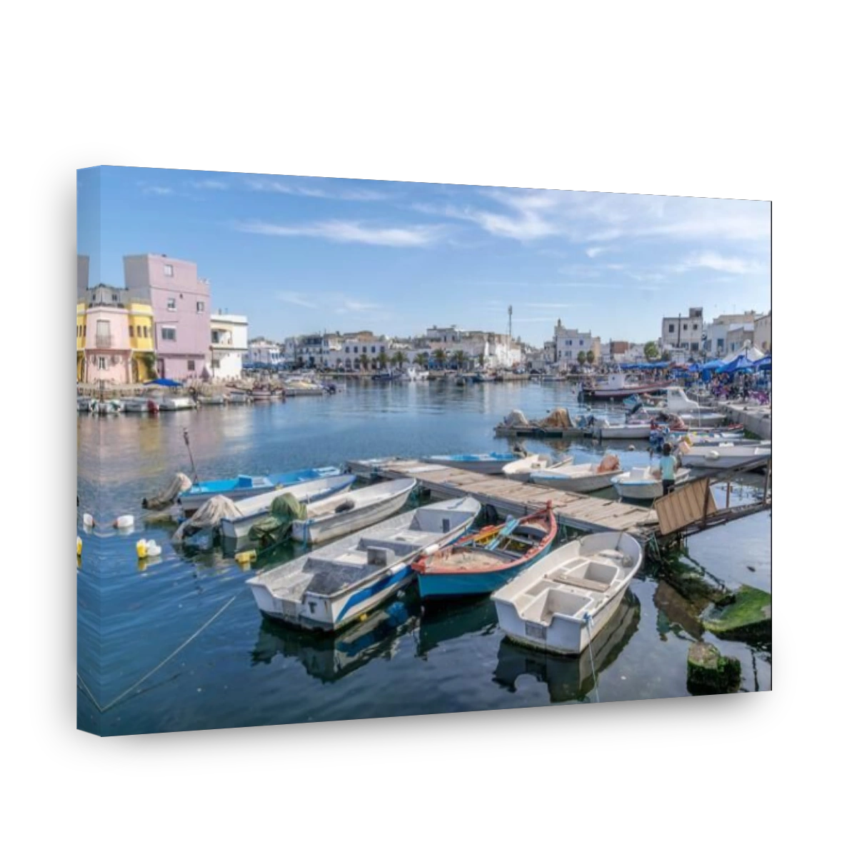 The boats and piers are at the Bizerte port harbor on the Mediterranean sea, with the houses along the promenade at north of Tunisia.