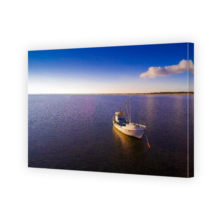 The Sorve lighthouse in Saaremaa Estonia and the small boat in the middle of the sea