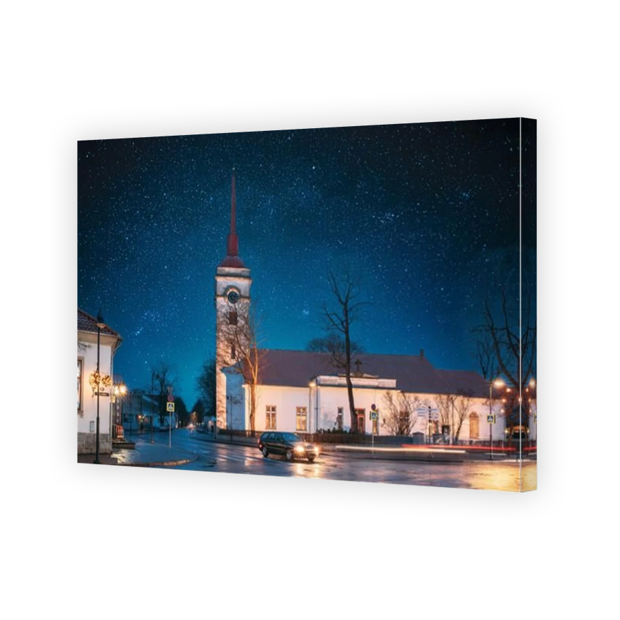 Kuressaare, Estonia. Kuressaare St Lawrence Church In Evening Night Illuminations. Amazing Bold Bright Blue Starry Sky Gradient. Travel To Estonia