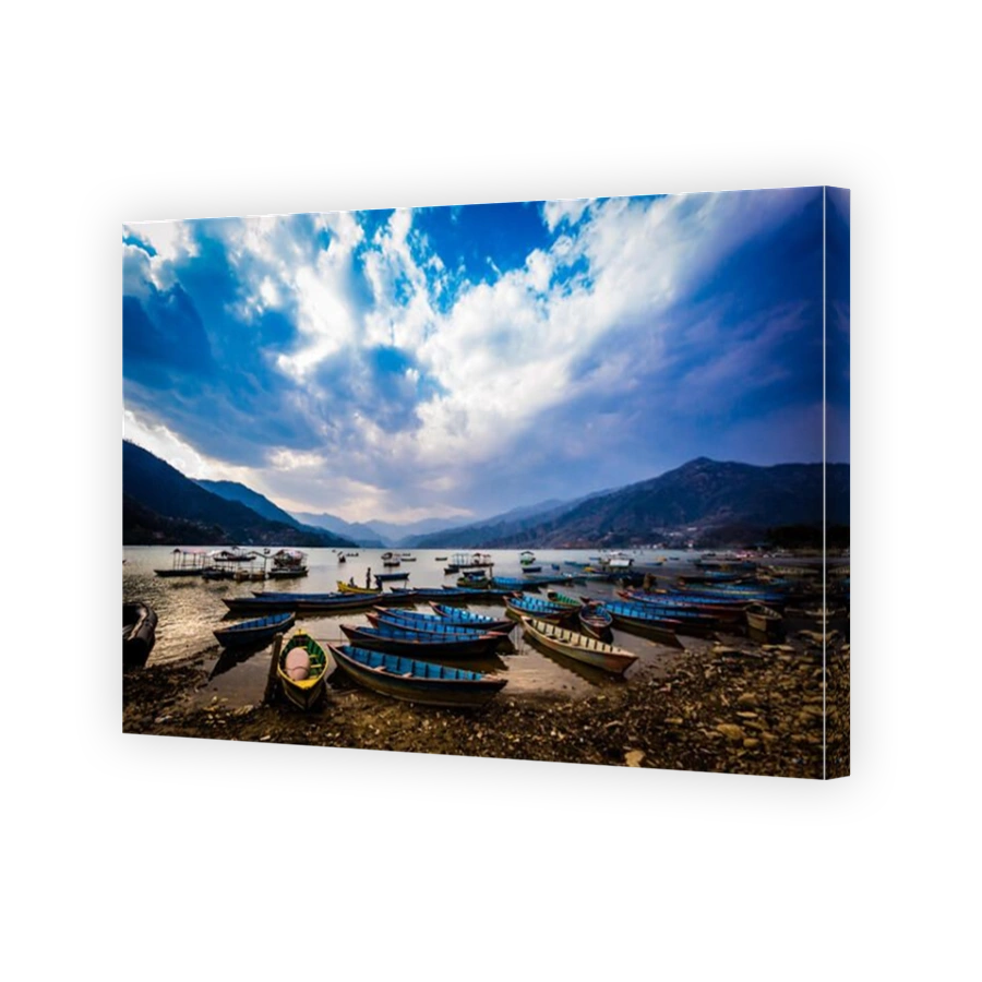 Boats docked on a lake at sunset in Pokhara, Nepal, Asia