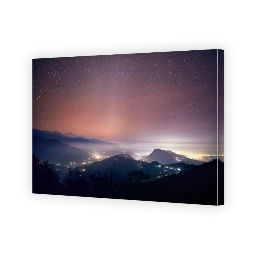 Lights of Pokhara city and villages at night starry sky at mountain range of Annapurna, Nepal