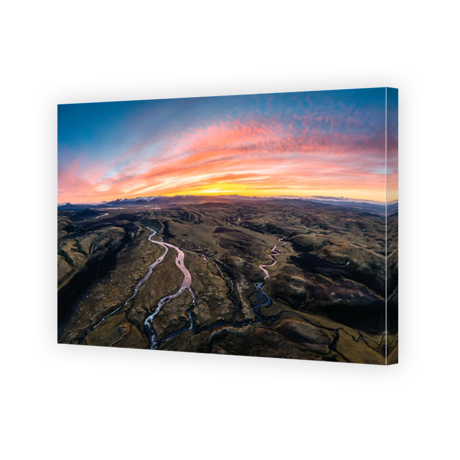 Aerial view of moss on lava field with river flowing in Icelandic highlands on wilderness in the sunset at Iceland