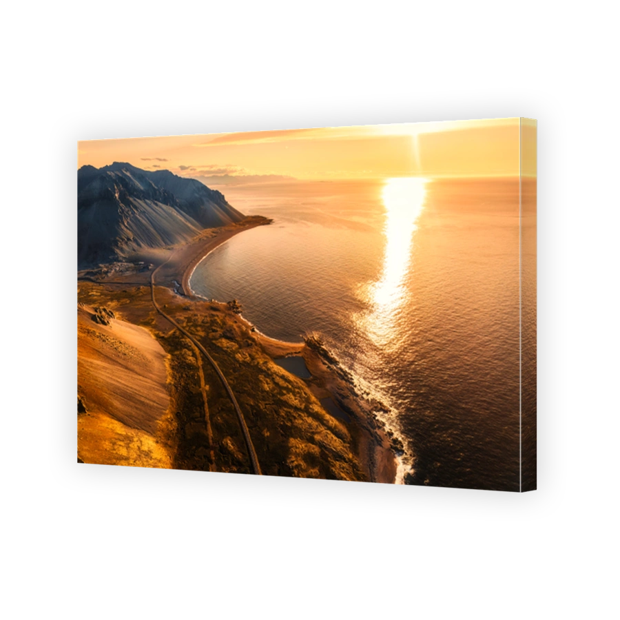 Beautiful sunrise over volcanic mountain range in rural scene by the ocean of peninsula at summer in Iceland