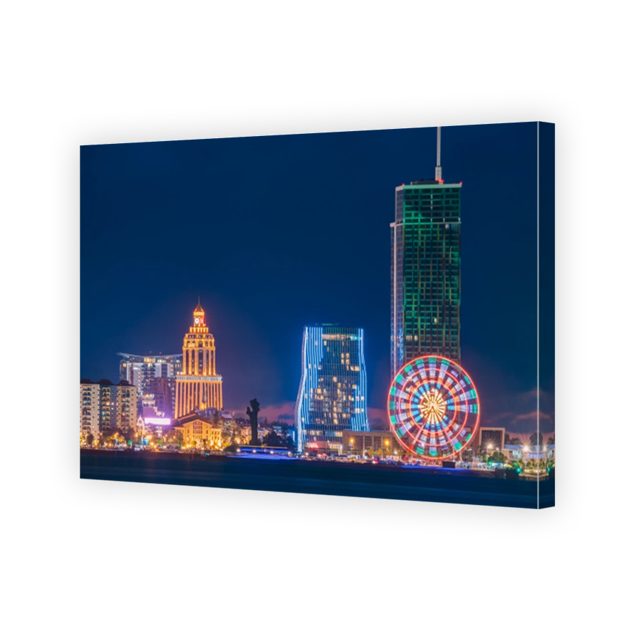 Batumi, Adjara, Georgia. Modern Architecture In Seafront Promenade. Miracle Park With Modern Buildings In Night Or Evening Illuminations Lights, Illuminated Resort Town Cityscape