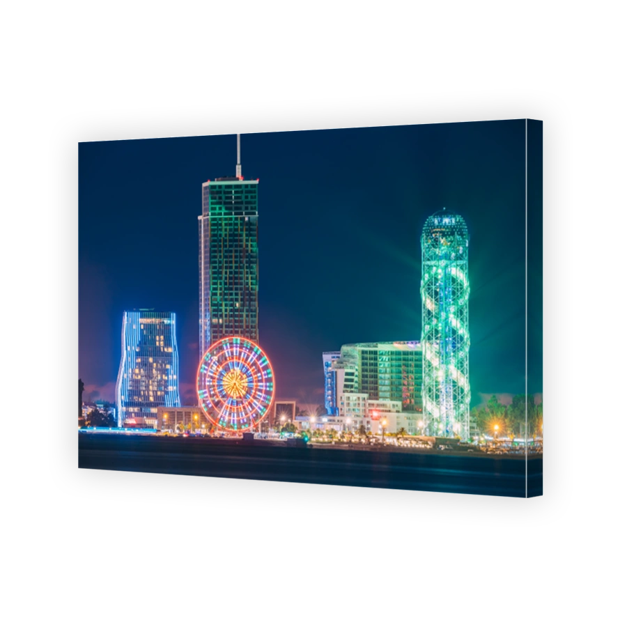Batumi, Adjara, Georgia. Modern Architecture In Seafront Promenade. Miracle Park With Modern Buildings In Night Or Evening Illuminations Lights, Illuminated Resort Town Cityscape