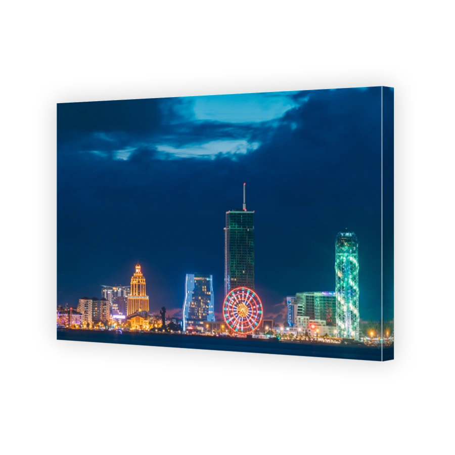 Batumi, Adjara, Georgia. Modern Architecture In Seafront Promenade. Miracle Park With Modern Buildings In Night Or Evening Illuminations Lights, Illuminated Resort Town Cityscape