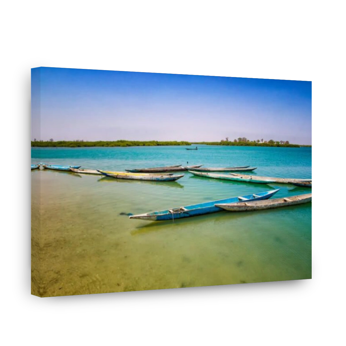 Wooden canoe on sea lagoon in Senegal in Africa. It is the Saloum National Nature Park, a bird sanctuary. In the background is blue sky and the island
